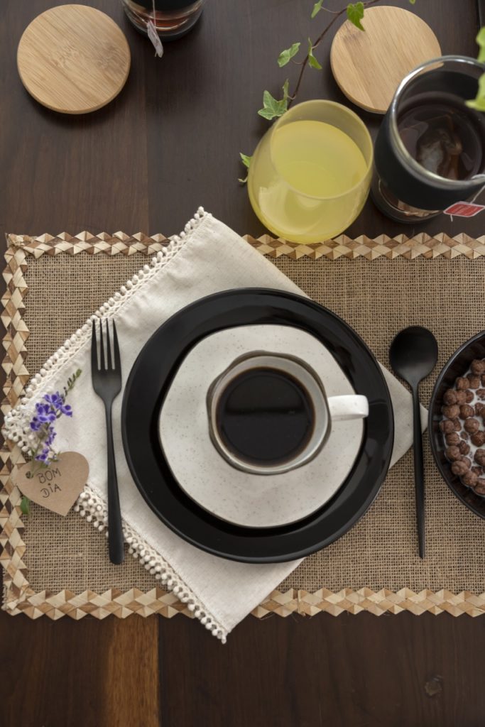Lugar na mesa simples para o Dia dos pais, com louças em tom de preto e areia.